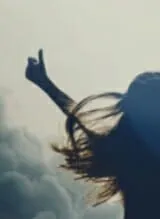 Woman celebrating with arms raised.