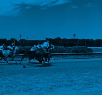Jockeys racing horses on a horse track