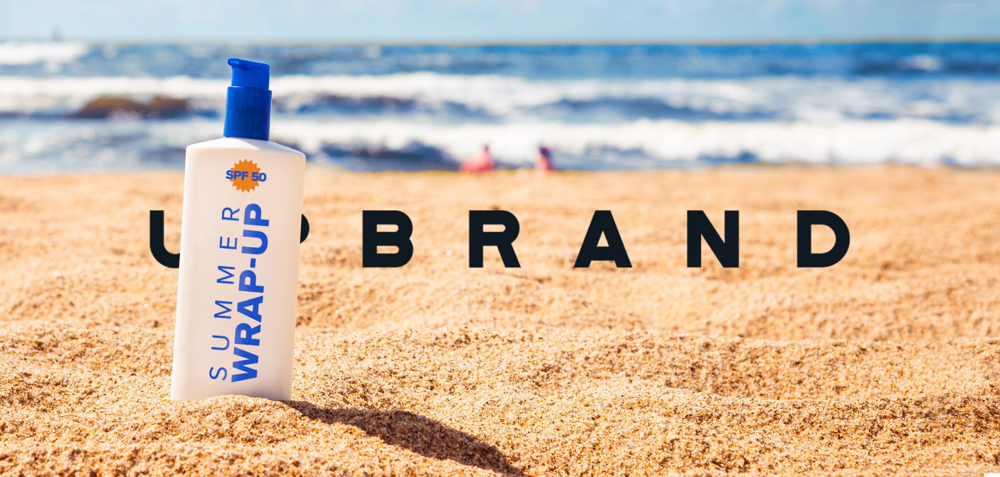 A picture of a beach with a bottle of sunscreen and the name UPBRAND behind the bottle