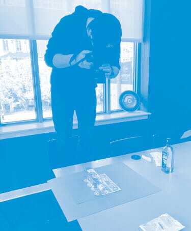 A man capturing an image of a table with his camera, showcasing its intricate design and arrangement.