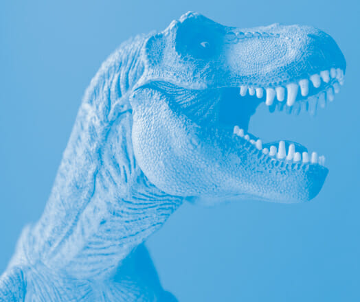 A blue T-Rex toy, mouth agape, ready to roar.