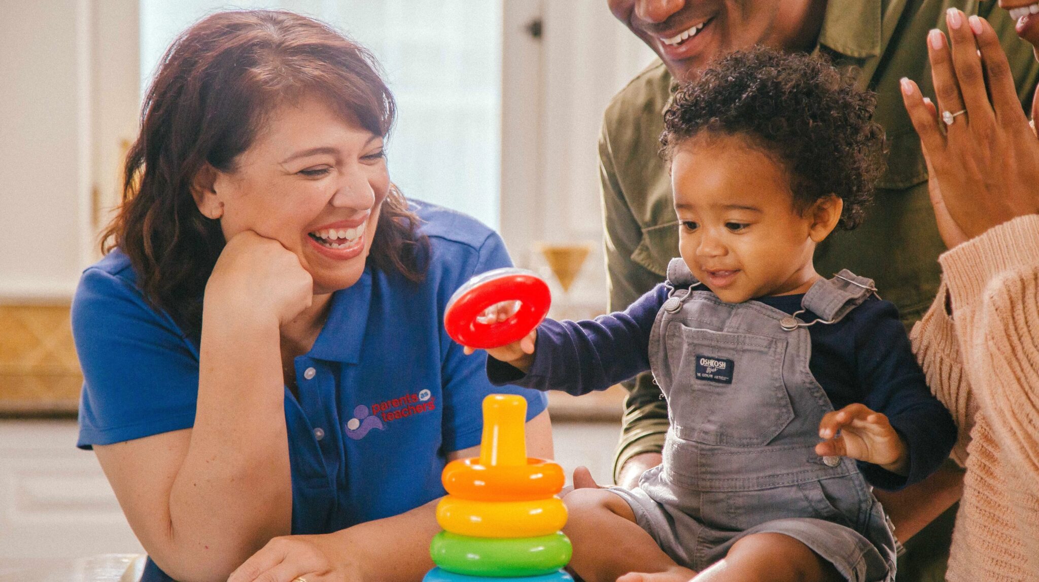 A toddler playing with an adult