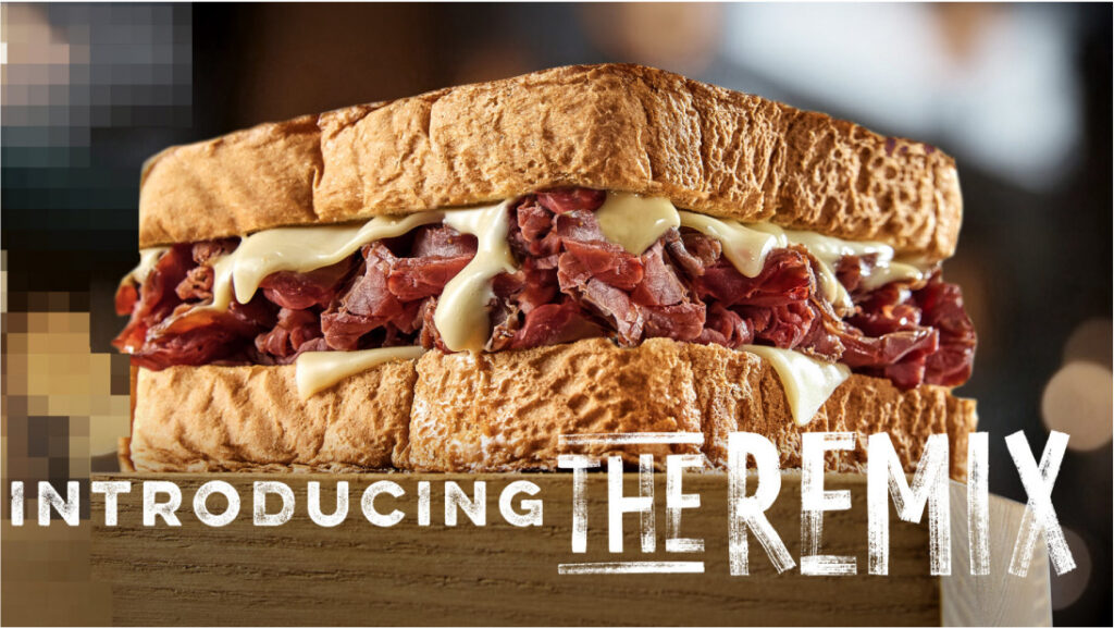 A close crop of the Lion's Choice Remix sandwich with the campaign wordmark across it.